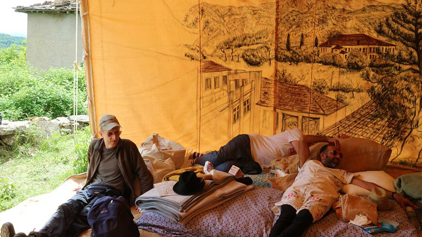 Restful activities inside the tent with host, Ruud Matthes, printmaker and advisor of the Tsarino Foundation, Bulgaria. Pictured here are Ruudd, Steven Frick and Nikhil Chopra; a detail of the drawing made in Ioaninna, Greece forms the backdrop, May 19, 2017. (Photo Courtesy: Madhavi Gore)